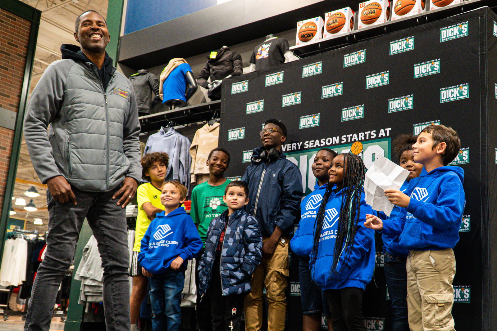 Charlie and children smiling at Dick's Sporting Goods