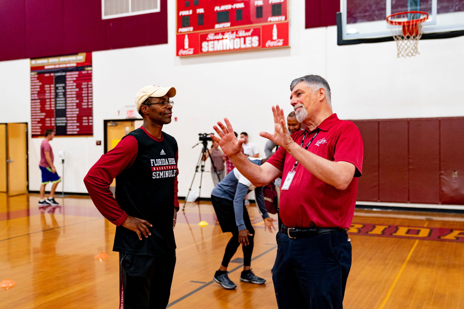 Charlie talking with someone at basketball clinic